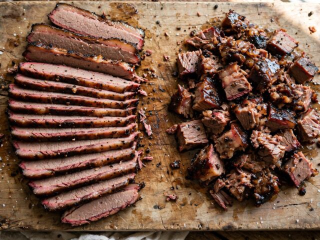 Side-by-side comparison of sliced smoked brisket flat and chopped smoked brisket point on a cutting board